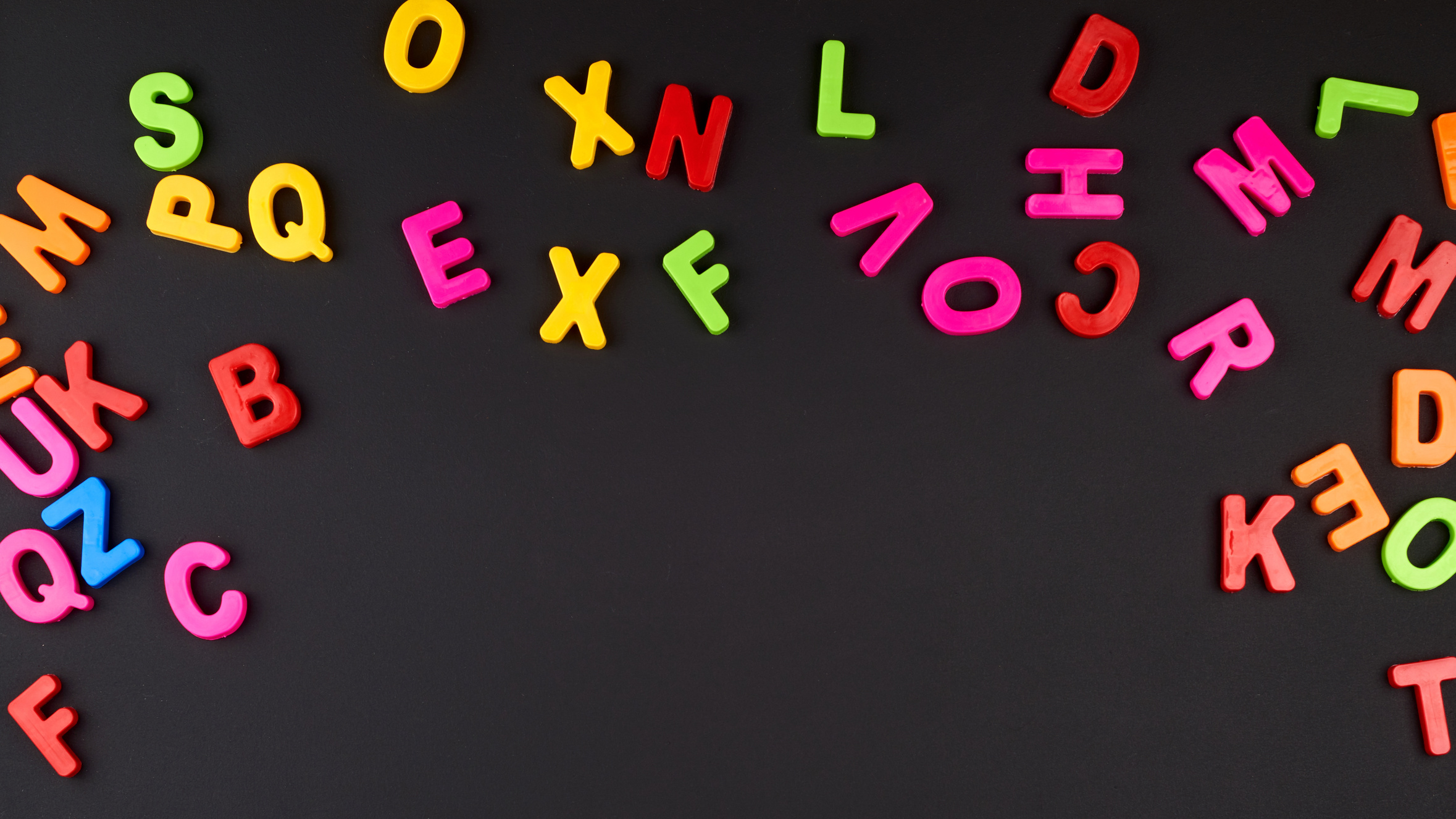 Colorful Plastic Letters on Blackboard